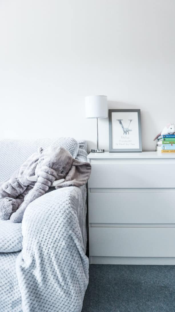 boy nursery with elephant toy on armchair