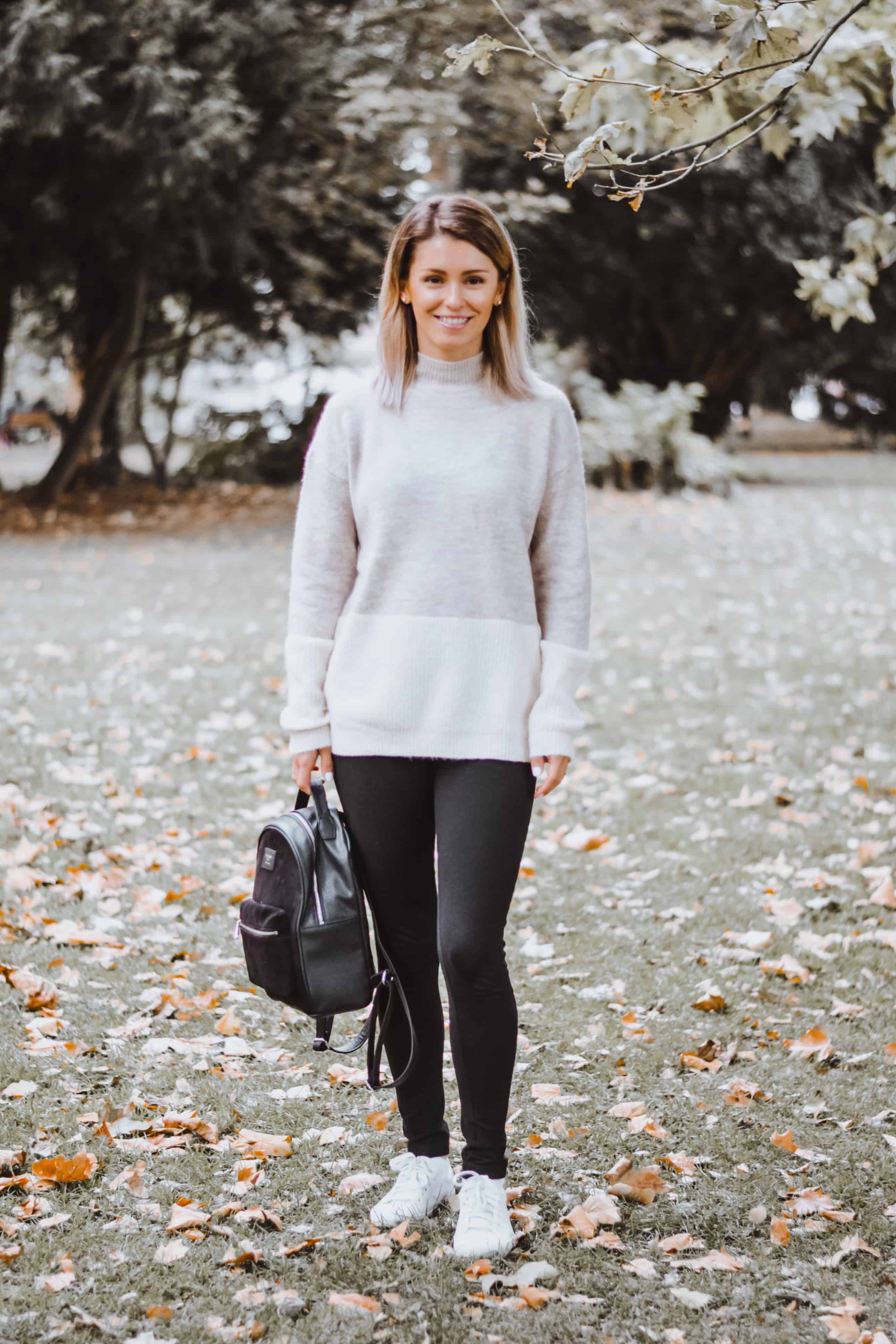 grey and cream sweater with leggings and black backpack style