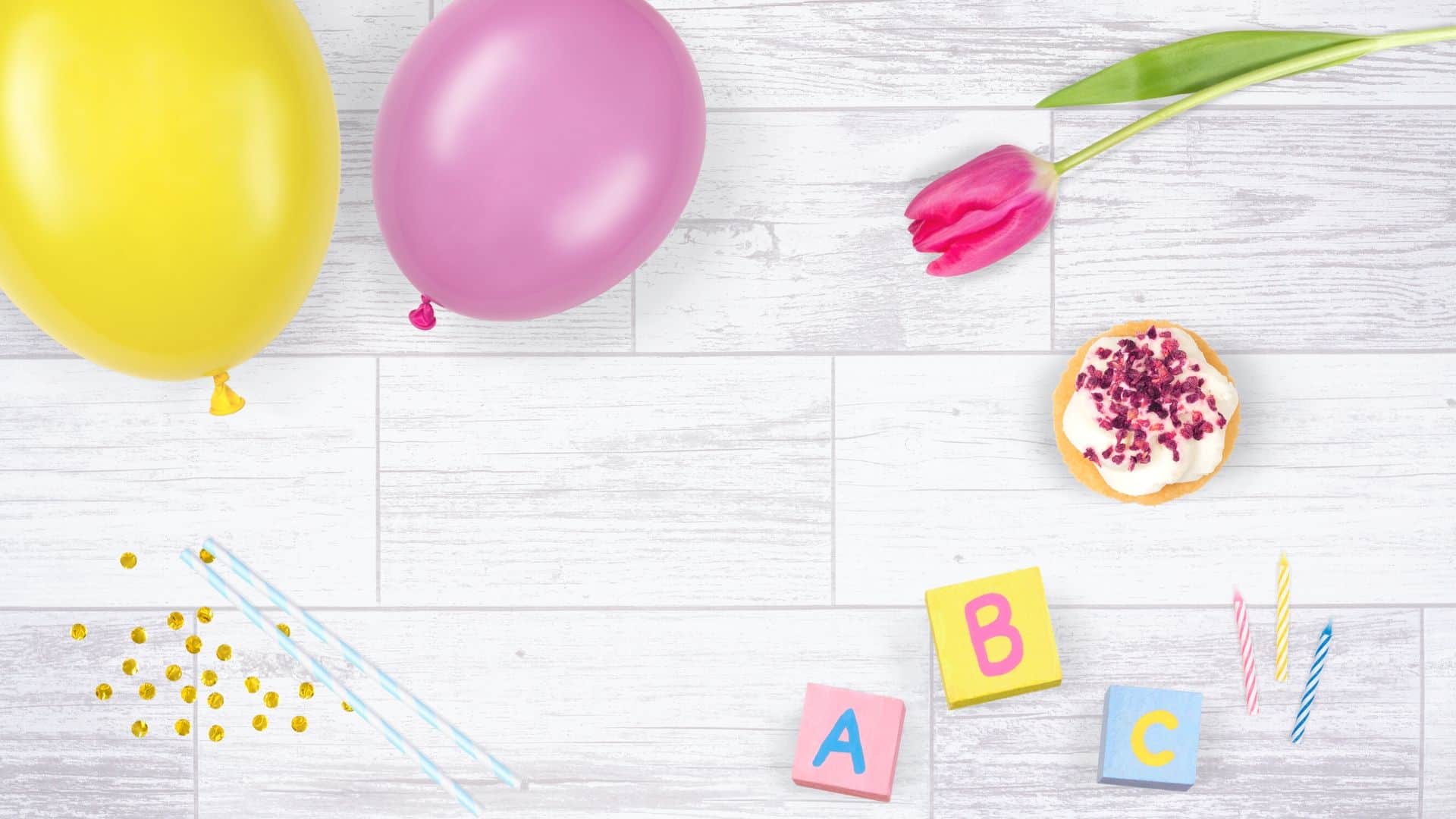 pink baby flatlay example with wooden board and kids props
