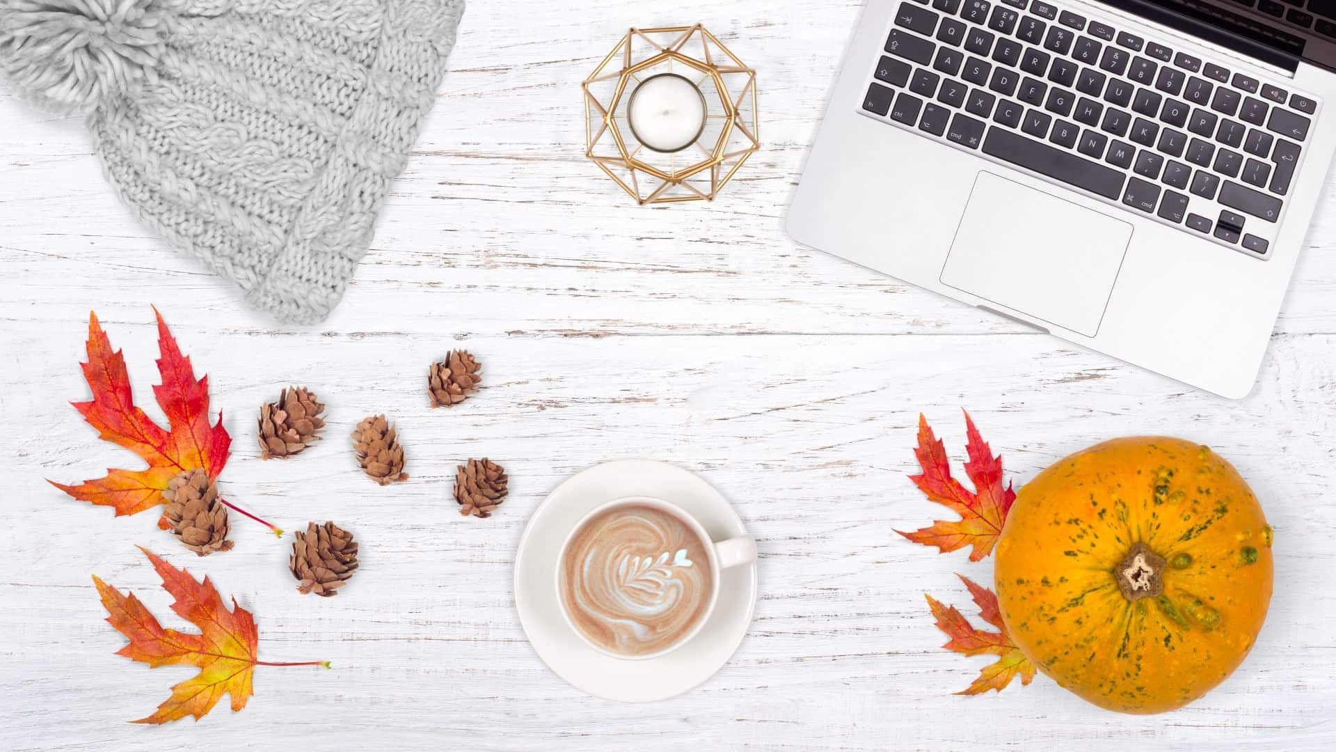 autumnal flatlay example with wooden background, pumpkins and leaves